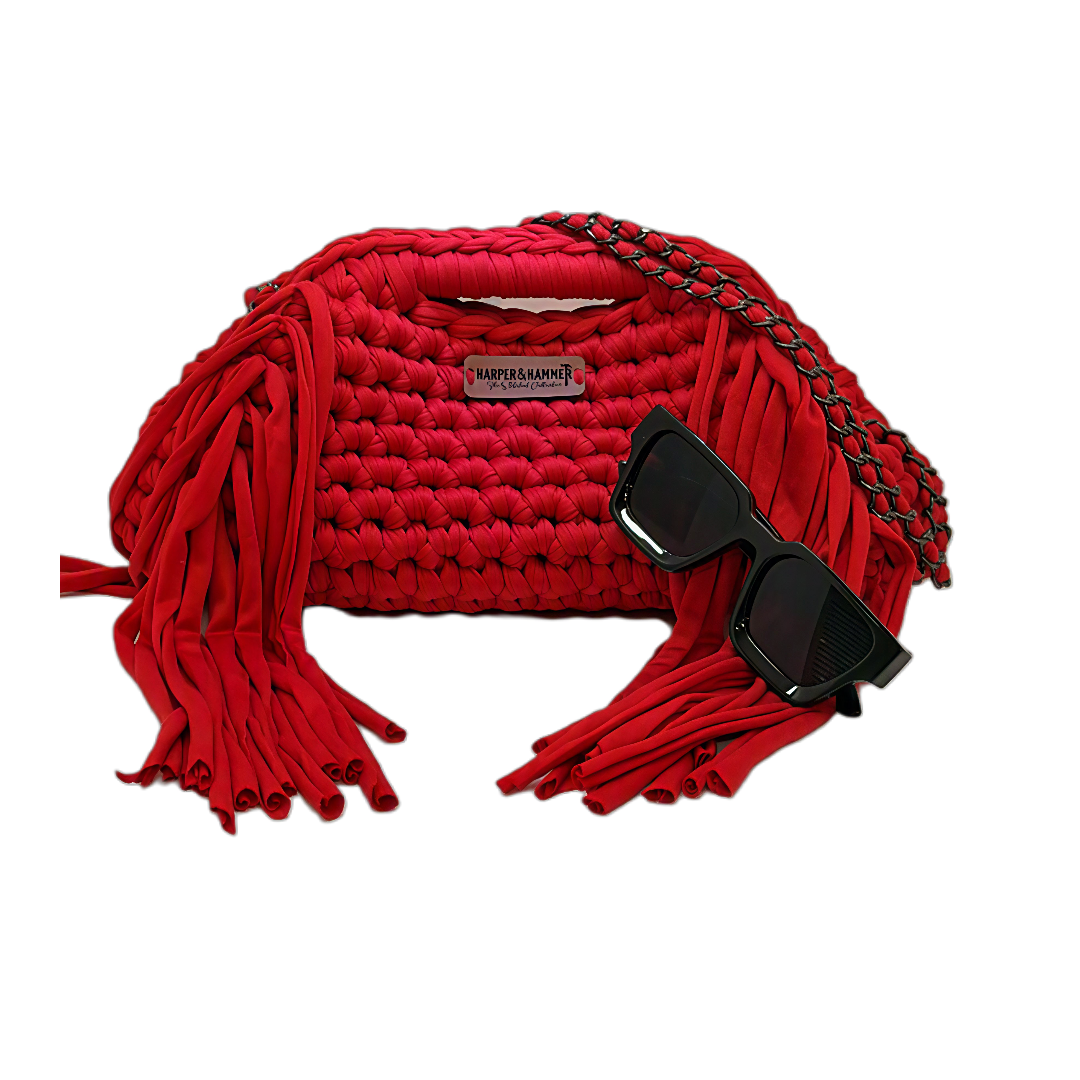 Red crochet fringe clutch with gunmetal chain strap and black sunglasses